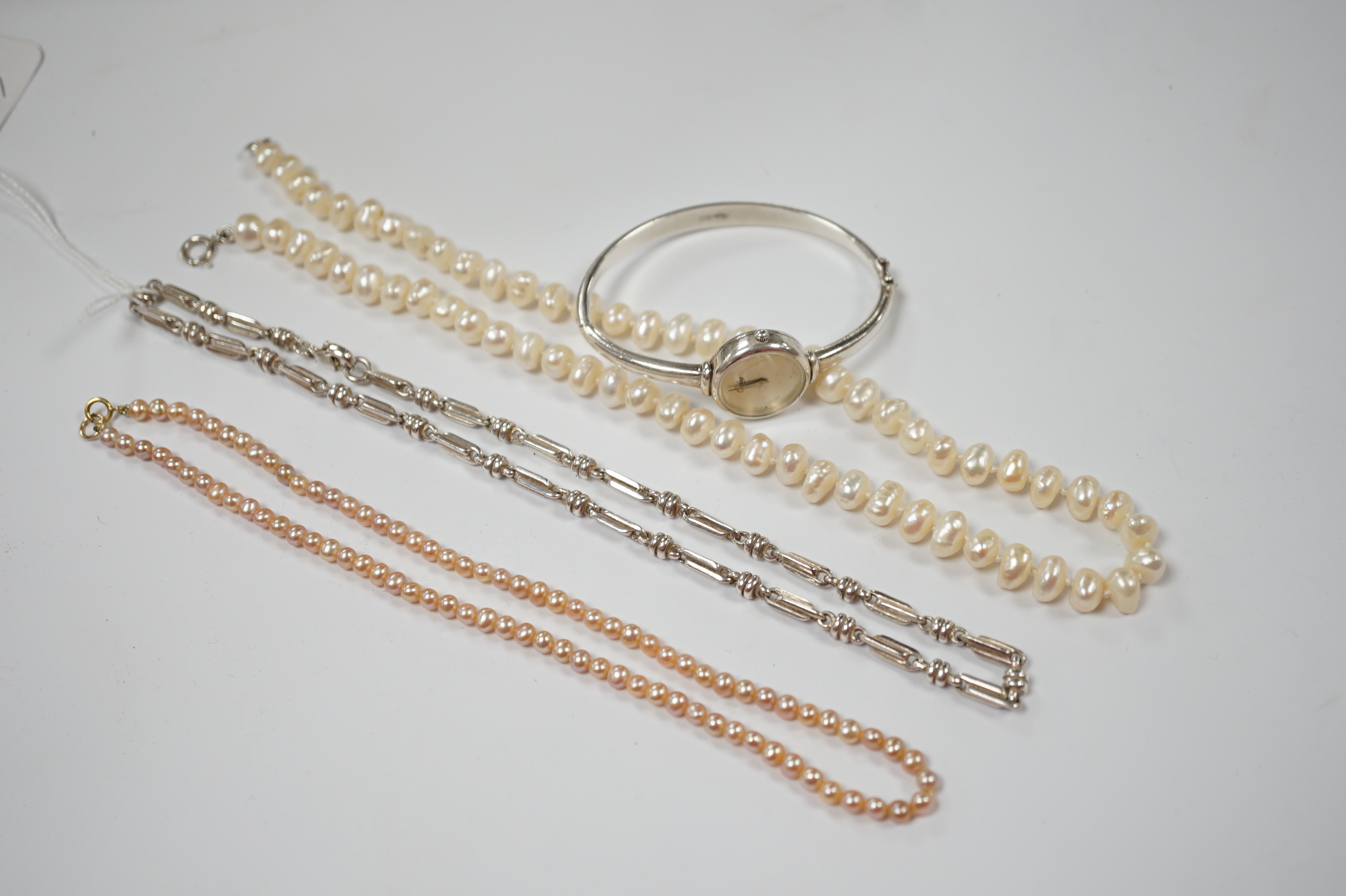 A modern 925 chain, a lady's 925 bangle watch and two cultured pearl necklaces.